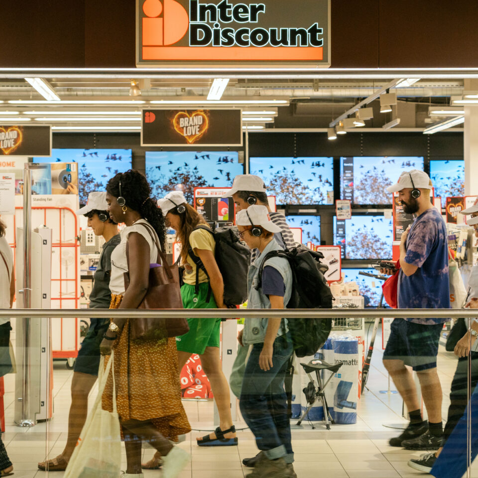 A group of people walking in a store